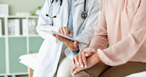Doctor and patient using a tablet.